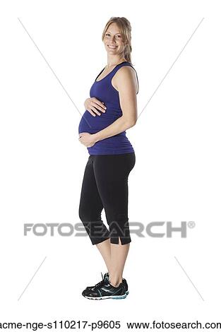 Portrait of young pregnant woman in sports clothing, studio shot View Large Photo Image Stock Photography - Portrait of young pregnant woman in sports clothing, studio shot. Fotosearch