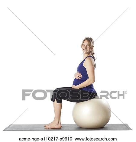 Portrait of young pregnant woman sitting on fitness ball, studio shot View Large Photo Image Stock Image - Portrait of young pregnant woman sitting on fitness ball, studio shot. Fotosearch