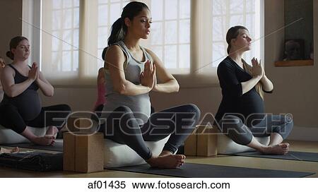 Pregnant woman sitting cross-legged and meditating in yoga class View Large Photo Image Stock Photography - Pregnant woman sitting cross-legged and meditating in yoga class. Fotosearch