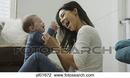 Profile of blurred mother and curious baby son sitting on floor and playing View Large Photo Image Stock Image - Profile of blurred mother and curious baby son sitting on floor and playing. Fotosearch