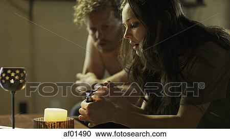 Profile of drug addicts cooking drugs in spoon on dingy sofa View Large Photo Image Stock Image - Profile of drug addicts cooking drugs in spoon on dingy sofa. Fotosearch