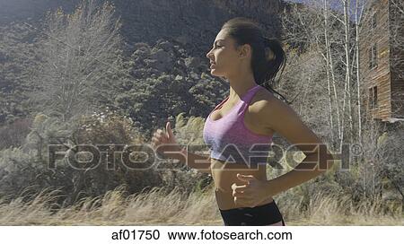 Profile of serene runner jogging in remote forest landscape View Large Photo Image Stock Image - Profile of serene runner jogging in remote forest landscape. Fotosearch