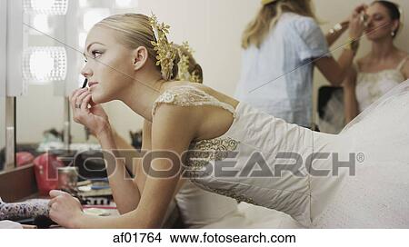 Profile of serious ballet dancer in costume applying makeup backstage before show View Large Photo Image Picture - Profile of serious ballet dancer in costume applying makeup backstage before show. Fotosearch