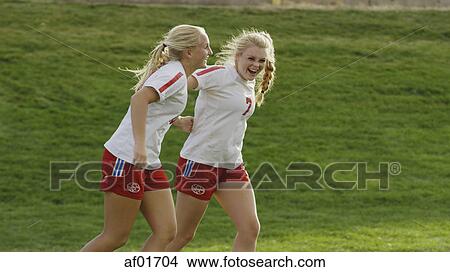 Proud athlete with soccer teammate cheering after game victory on field View Large Photo Image Picture - Proud athlete with soccer teammate cheering after game victory on field. Fotosearch