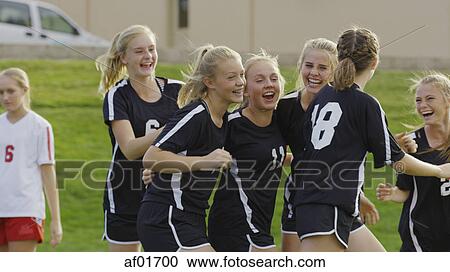 Proud athlete with soccer teammates cheering after game victory on field View Large Photo Image Stock Image - Proud athlete with soccer teammates cheering after game victory on field. Fotosearch