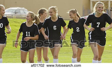 Proud athlete with soccer teammates cheering after game victory on field View Large Photo Image Stock Image - Proud athlete with soccer teammates cheering after game victory on field. Fotosearch