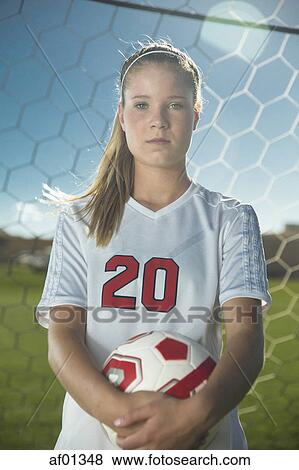 Proud goalie holding soccer ball in goal on sunny day View Large Photo Image Stock Photo - Proud goalie holding soccer ball in goal on sunny day. Fotosearch