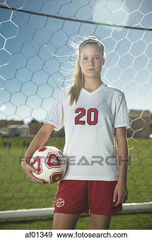 Proud goalie holding soccer ball in goal on sunny day View Large Photo Image Stock Photo - Proud goalie holding soccer ball in goal on sunny day. Fotosearch
