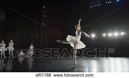 Rear view of serious ballet dancer in costume performing onstage in show View Large Photo Image Stock Photo - Rear view of serious ballet dancer in costume performing onstage in show. Fotosearch