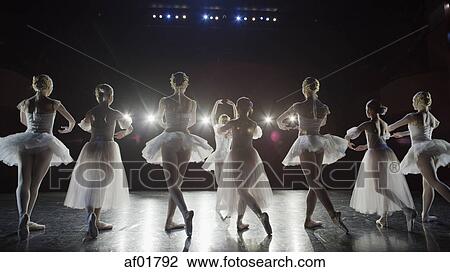 Rear view of serious ballet dancers in costume performing onstage in show View Large Photo Image Stock Image - Rear view of serious ballet dancers in costume performing onstage in show. Fotosearch