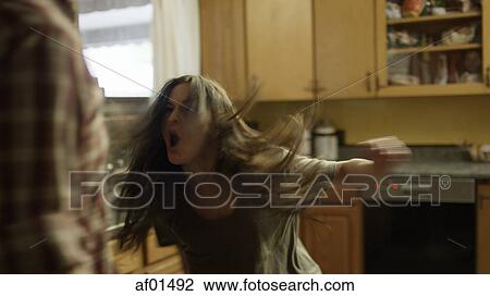 Selective focus blurred view of angry girlfriend shouting at boyfriend in kitchen View Large Photo Image Stock Image - Selective focus blurred view of angry girlfriend shouting at boyfriend in kitchen. Fotosearch