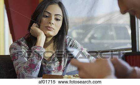 Selective focus view of annoyed girlfriend with distracted boyfriend using smartphone at table in cafe View Large Photo Image Stock Photography - Selective focus view of annoyed girlfriend with distracted boyfriend using smartphone at table in cafe. Fotosearch