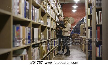 Selective focus view of boyfriend and girlfriend reading book in bookstore View Large Photo Image Stock Photo - Selective focus view of boyfriend and girlfriend reading book in bookstore. Fotosearch