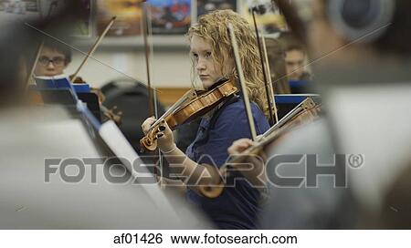 Selective focus view of serious teenage girl musician playing violin in band class View Large Photo Image Stock Photograph - Selective focus view of serious teenage girl musician playing violin in band class. Fotosearch