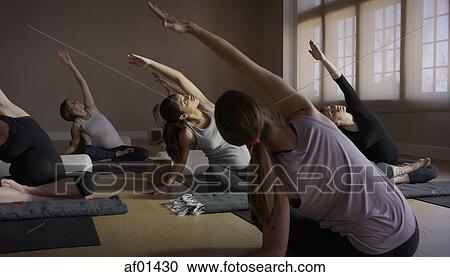 Selective focus view of tranquil women stretching in yoga class View Large Photo Image Stock Image - Selective focus view of tranquil women stretching in yoga class. Fotosearch