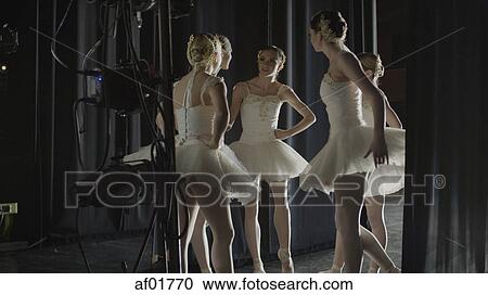 Serious ballet dancers in costume standing backstage during show View Large Photo Image Stock Image - Serious ballet dancers in costume standing backstage during show. Fotosearch