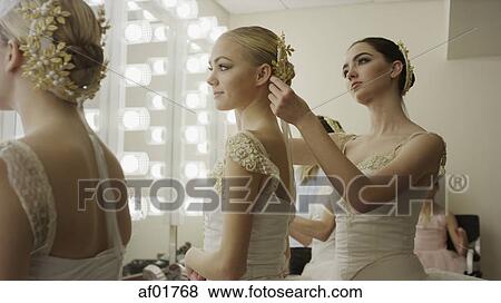Serious ballet dancers in costume styling hair backstage before show View Large Photo Image Stock Photo - Serious ballet dancers in costume styling hair backstage before show. Fotosearch