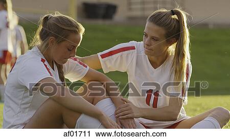 Serious soccer athlete comforting teammate after losing game outdoors View Large Photo Image Stock Image - Serious soccer athlete comforting teammate after losing game outdoors. Fotosearch
