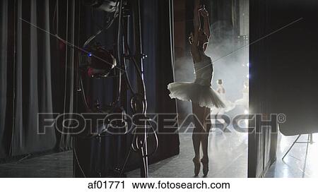 Silhouette of serious ballet dancer in costume ready to dance onstage during show View Large Photo Image Stock Image - Silhouette of serious ballet dancer in costume ready to dance onstage during show. Fotosearch