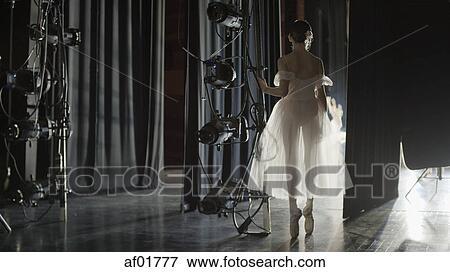 Silhouette of serious ballet dancer in costume ready to dance onstage during show View Large Photo Image Stock Photo - Silhouette of serious ballet dancer in costume ready to dance onstage during show. Fotosearch