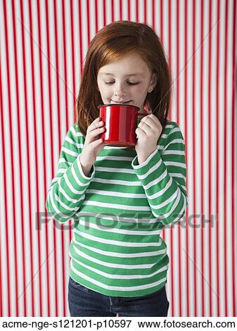 Studio portrait of girl (4-5) drinking from red mug View Large Photo Image Stock Photo - Studio portrait of girl (4-5) drinking from red mug. Fotosearch