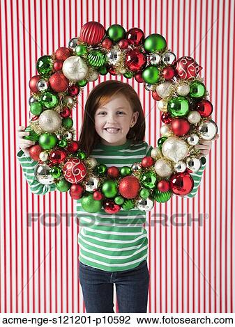 Studio portrait of girl (4-5) holding Christmas decoration View Large Photo Image Stock Image - Studio portrait of girl (4-5) holding Christmas decoration. Fotosearch