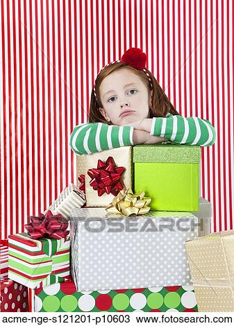 Studio portrait of girl (4-5) with stack of Christmas gifts View Large Photo Image Stock Image - Studio portrait of girl (4-5) with stack of Christmas gifts. Fotosearch