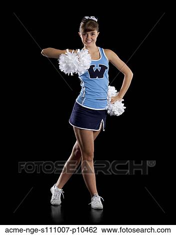 Stock Image - Studio shot of cheerleader (16-17) striking pose. Fotosearch