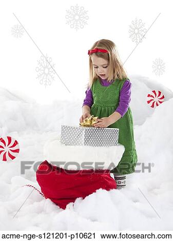 Studio shot of girl (18-23 months) with Christmas gifts View Large Photo Image Stock Image - Studio shot of girl (18-23 months) with Christmas gifts. Fotosearch