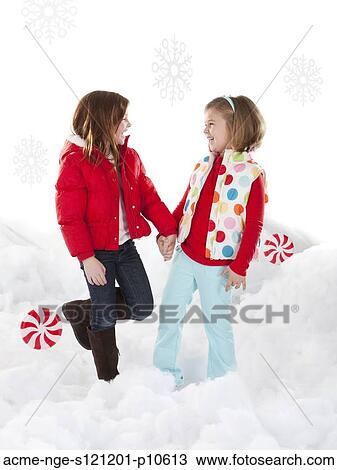 Studio shot of girls (4-5, 6-7) standing in snow View Large Photo Image Stock Image - Studio shot of girls (4-5, 6-7) standing in snow. Fotosearch