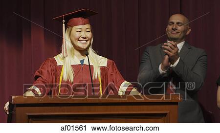 Teacher applauding smiling student speaking at podium on stage during graduation ceremony View Large Photo Image Stock Image - Teacher applauding smiling student speaking at podium on stage during graduation ceremony. Fotosearch