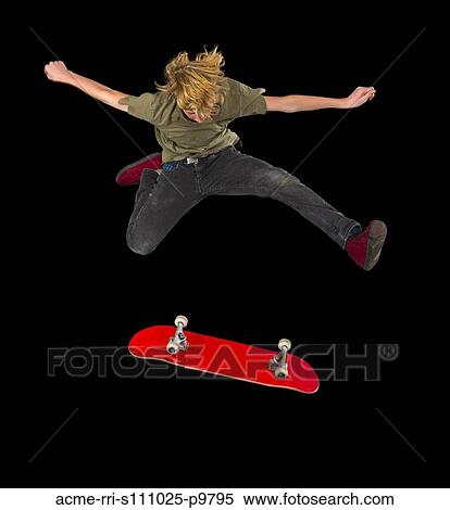 Teenage boy (14-15) performing ollie stunt on skateboard View Large Photo Image Stock Photography - Teenage boy (14-15) performing ollie stunt on skateboard. Fotosearch