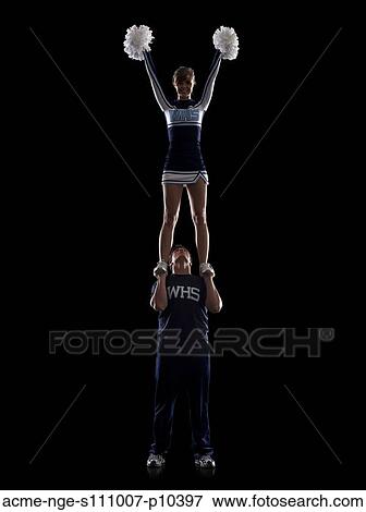 Stock Photo - Teenage sportsman(16-17) holding aloft teenage cheerleader girl (16-17) . Fotosearch