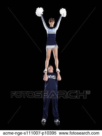 Stock Photography - Teenage sportsman(16-17) holding aloft teenage cheerleader girl (16-17) . Fotosearch