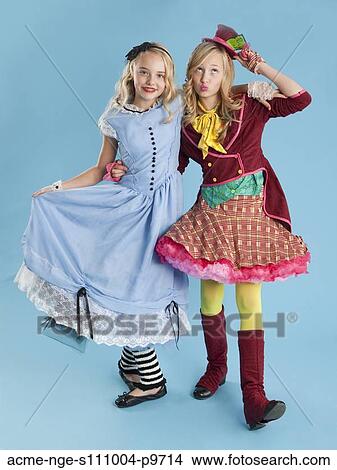 Two girls (10-11) in Alice in Wonderland costumes for Halloween View Large Photo Image Picture - Two girls (10-11) in Alice in Wonderland costumes for Halloween. Fotosearch