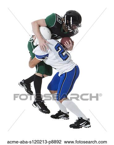 Two male players of American football fighting for ball, studio shot View Large Photo Image Stock Image - Two male players of American football fighting for ball, studio shot. Fotosearch