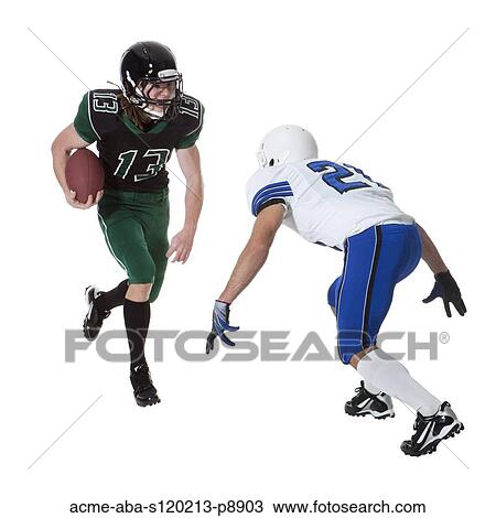 Two male players of American football fighting for ball, studio shot View Large Photo Image Stock Image - Two male players of American football fighting for ball, studio shot. Fotosearch