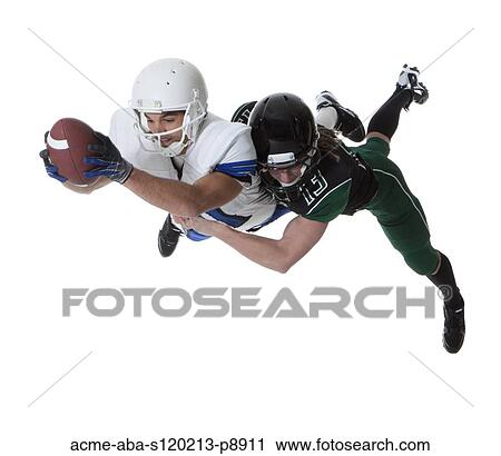 Two male players of American football fighting for ball, studio shot View Large Photo Image Stock Image - Two male players of American football fighting for ball, studio shot. Fotosearch