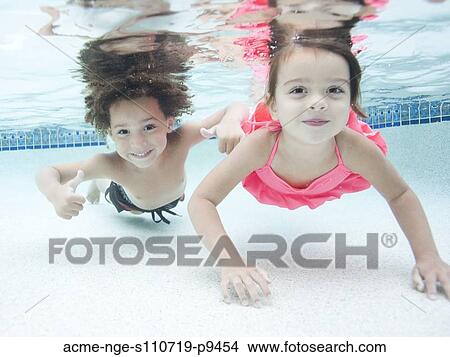 Picture - USA, Utah, Orem, Boy (4-5) and girl (4-5) swimming in pool. Fotosearch