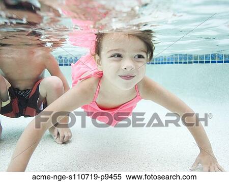 Stock Photography - USA, Utah, Orem, Boy (4-5) and girl (4-5) swimming in pool. Fotosearch