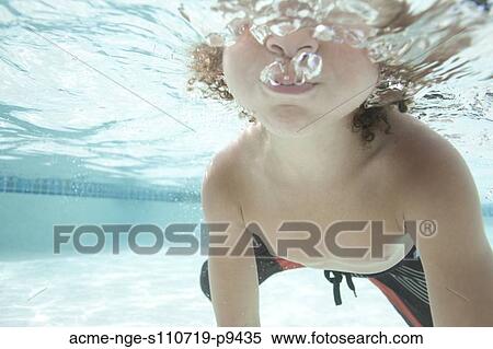 USA, Utah, Orem, Boy (4-5) swimming in swimming pool View Large Photo Image Stock Photography - USA, Utah, Orem, Boy (4-5) swimming in swimming pool. Fotosearch