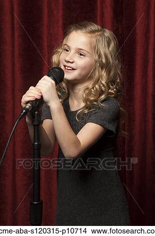 USA, Utah, Orem, Portrait of girl (8-9) singing with microphone View Large Photo Image Picture - USA, Utah, Orem, Portrait of girl (8-9) singing with microphone. Fotosearch