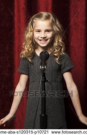 USA, Utah, Orem, Portrait of girl (8-9) singing with microphone View Large Photo Image Stock Image - USA, Utah, Orem, Portrait of girl (8-9) singing with microphone. Fotosearch