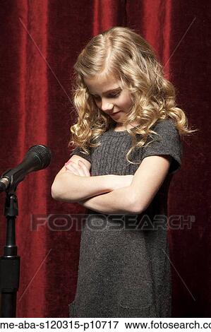 USA, Utah, Orem, Portrait of girl (8-9) with arms crossed standing in front of microphone View Large Photo Image Stock Photo - USA, Utah, Orem, Portrait of girl (8-9) with arms crossed standing in front of microphone. Fotosearch