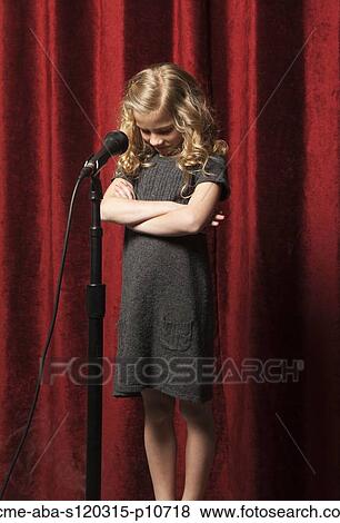 USA, Utah, Orem, Portrait of girl (8-9) with arms crossed standing in front of microphone View Large Photo Image Stock Photo - USA, Utah, Orem, Portrait of girl (8-9) with arms crossed standing in front of microphone. Fotosearch