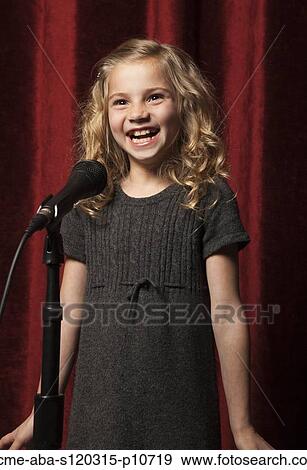 USA, Utah, Orem, Portrait of girl (8-9) singing with microphone View Large Photo Image Stock Photo - USA, Utah, Orem, Portrait of girl (8-9) singing with microphone. Fotosearch