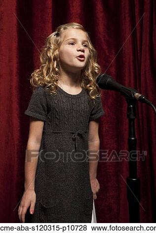 USA, Utah, Orem, Portrait of girl (8-9) singing with microphone View Large Photo Image Stock Photo - USA, Utah, Orem, Portrait of girl (8-9) singing with microphone. Fotosearch