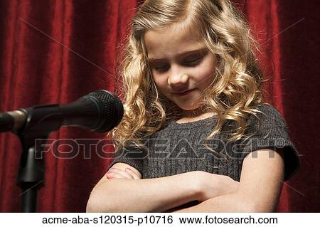 USA, Utah, Orem, Portrait of girl (8-9) with arms crossed standing in front of microphone View Large Photo Image Stock Photograph - USA, Utah, Orem, Portrait of girl (8-9) with arms crossed standing in front of microphone. Fotosearch