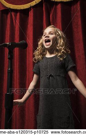 USA, Utah, Orem, Portrait of girl (8-9) singing with microphone View Large Photo Image Stock Photography - USA, Utah, Orem, Portrait of girl (8-9) singing with microphone. Fotosearch