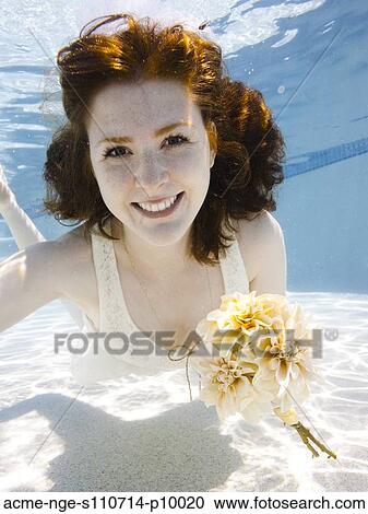 USA, Utah, Orem, Portrait of young woman with bouquet under water View Large Photo Image Stock Image - USA, Utah, Orem, Portrait of young woman with bouquet under water. Fotosearch